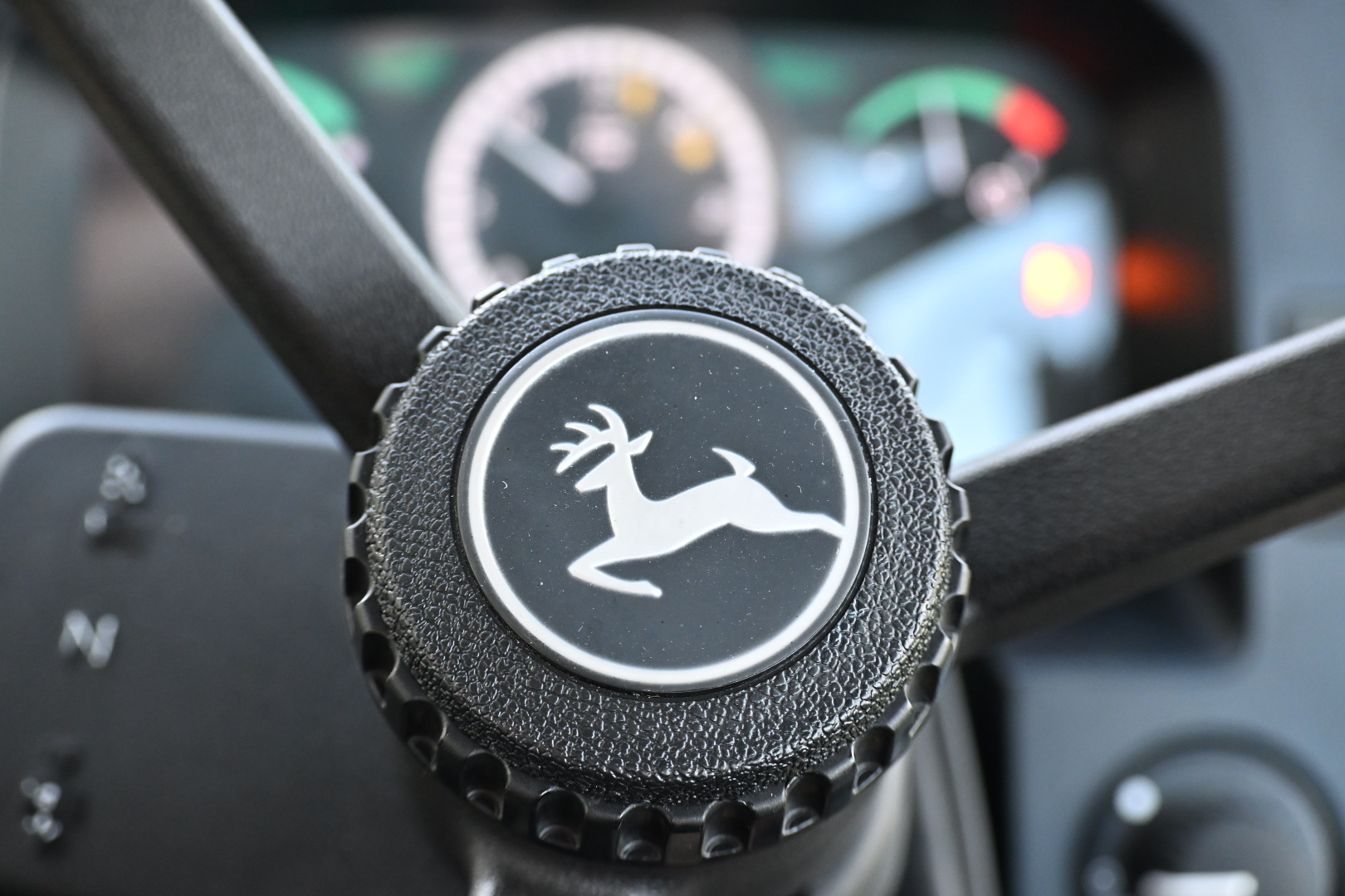 A detail of the John Deere tractor steering wheel